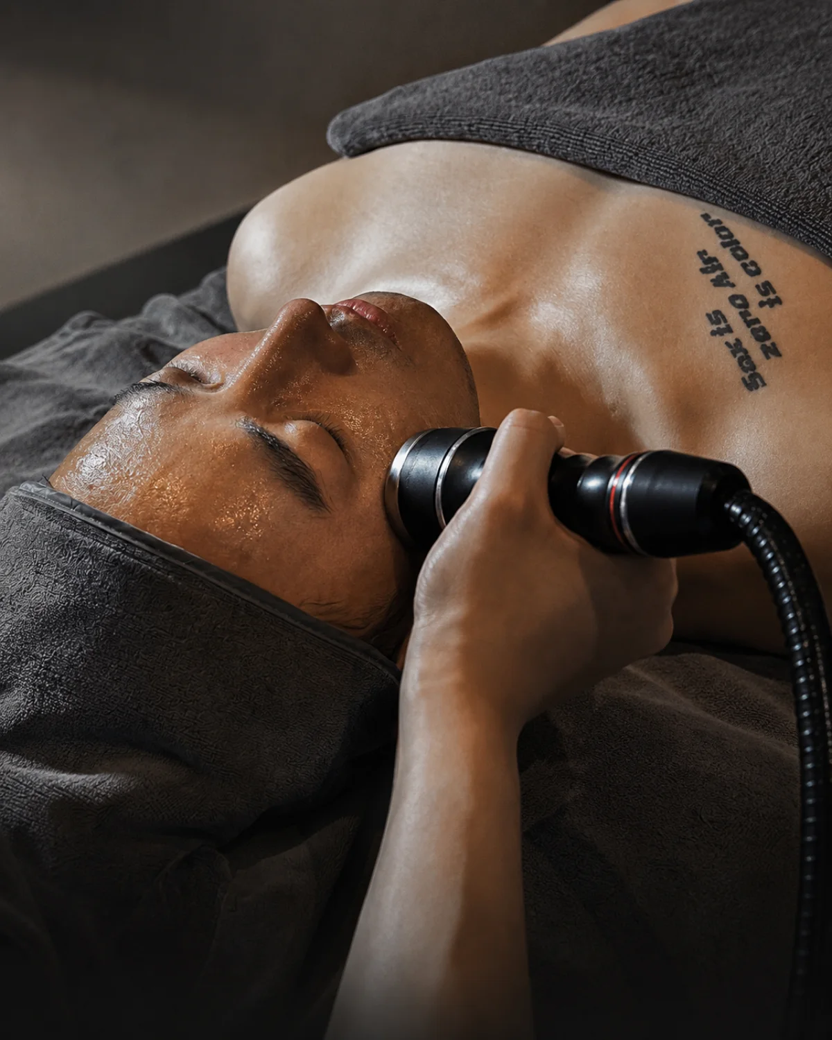 A professional facial treatment using a handheld skincare device